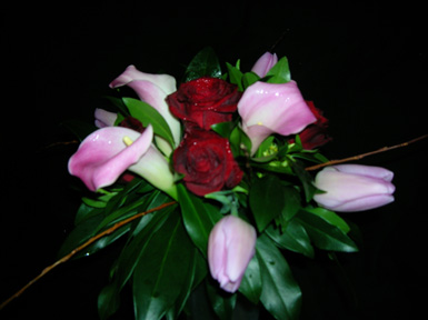 tulips, cala lilies and roses with greenery and twigs