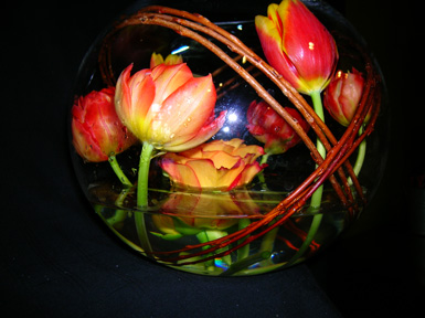 tulips and painted rose wrapped inside glass bowl